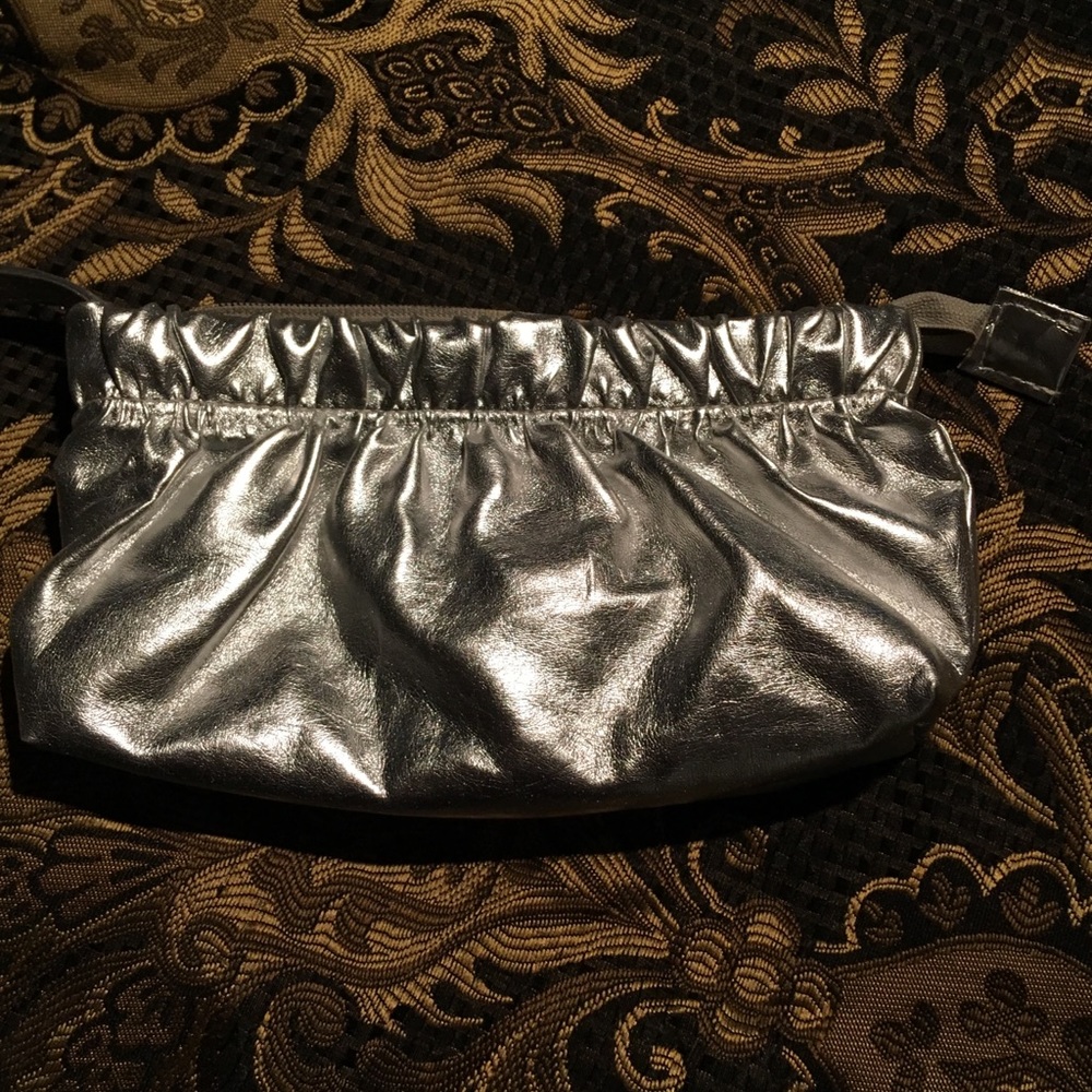 **SOLD**. 
Chi silver clutch with wrist strap